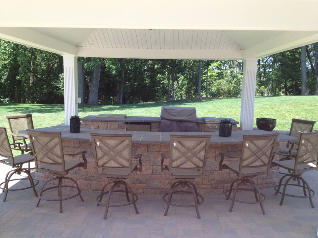 Outdoor bar and kitchen under a white pavilion
