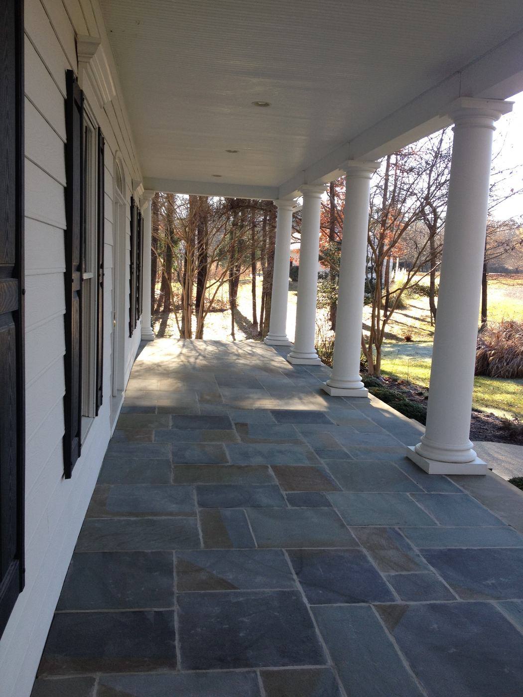 Flagstone porch floor along a columned front porch