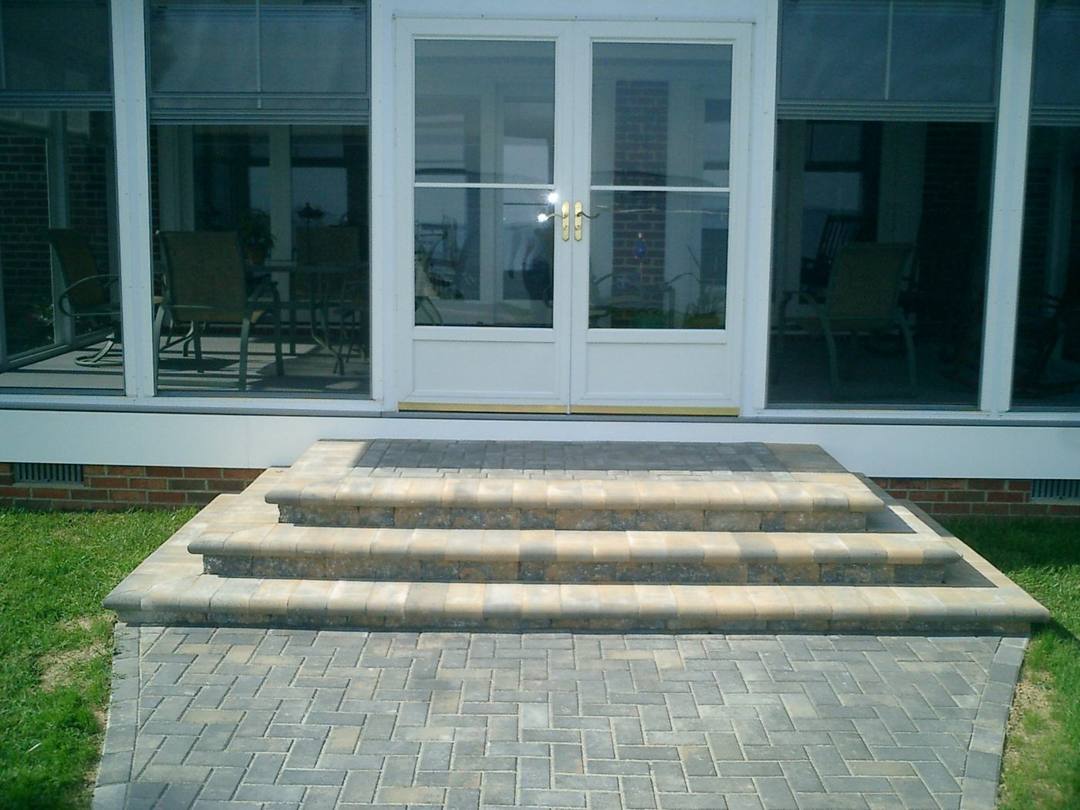 Wide paver steps to a sunroom door