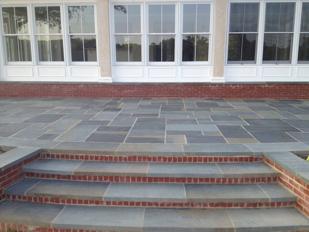 Bluestone and brick steps up to a flagstone patio