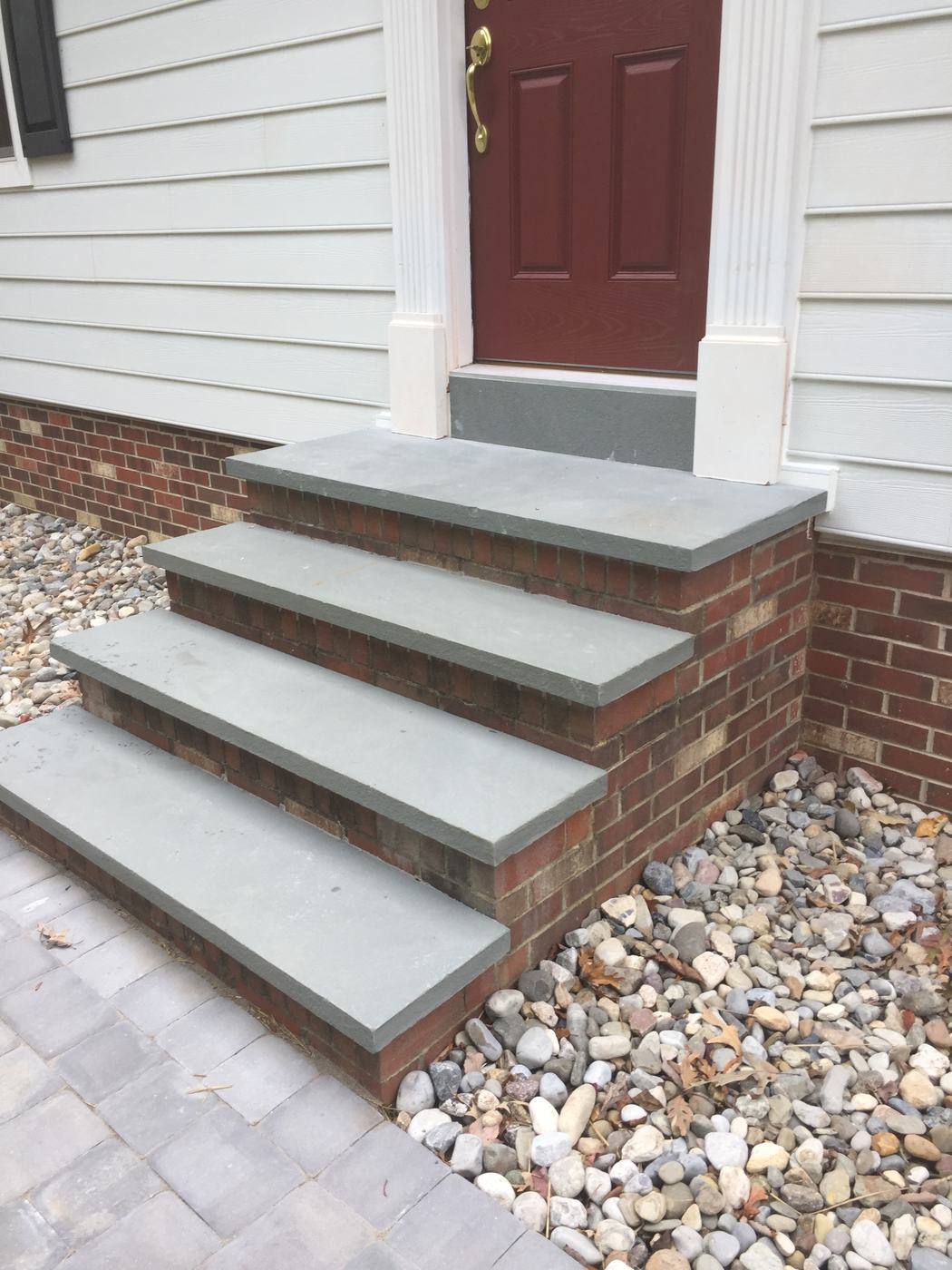 Bluestone and brick steps bordered by river rock