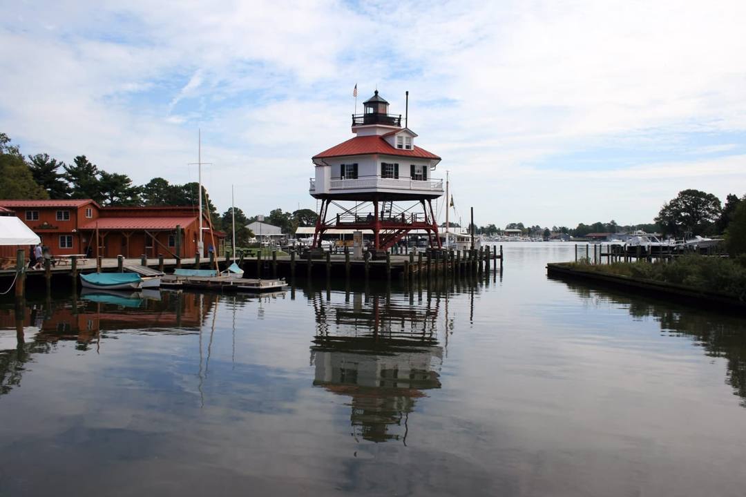 Drum Point Lighthouse reflected in the water at the Calvert Marine Museum in Solomons, Maryland